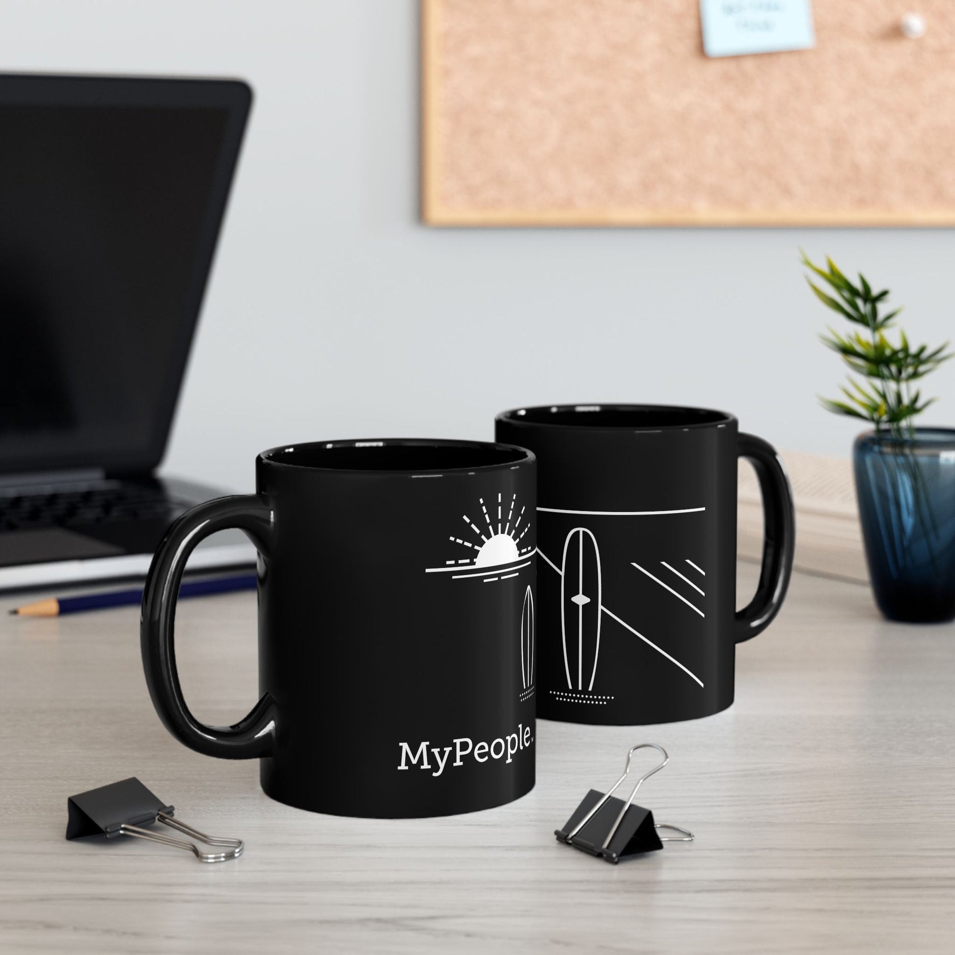 Two ceramic mugs featuring the MyPeople Surfing line illustration sitting on a desk.