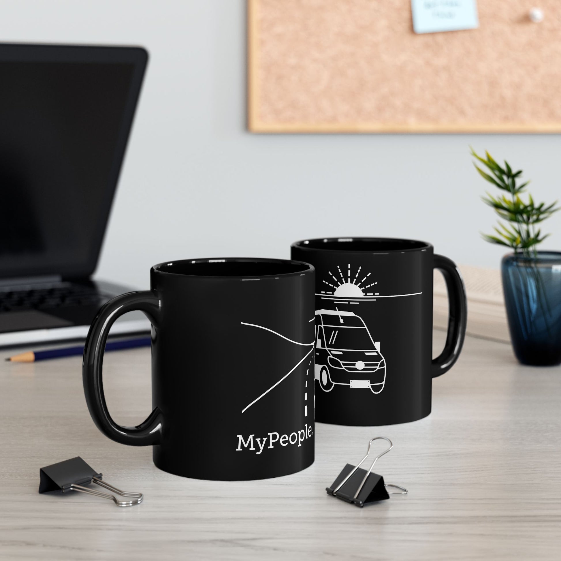 Two ceramic mugs featuring the MyPeople Van Life line illustration sitting on a desk.