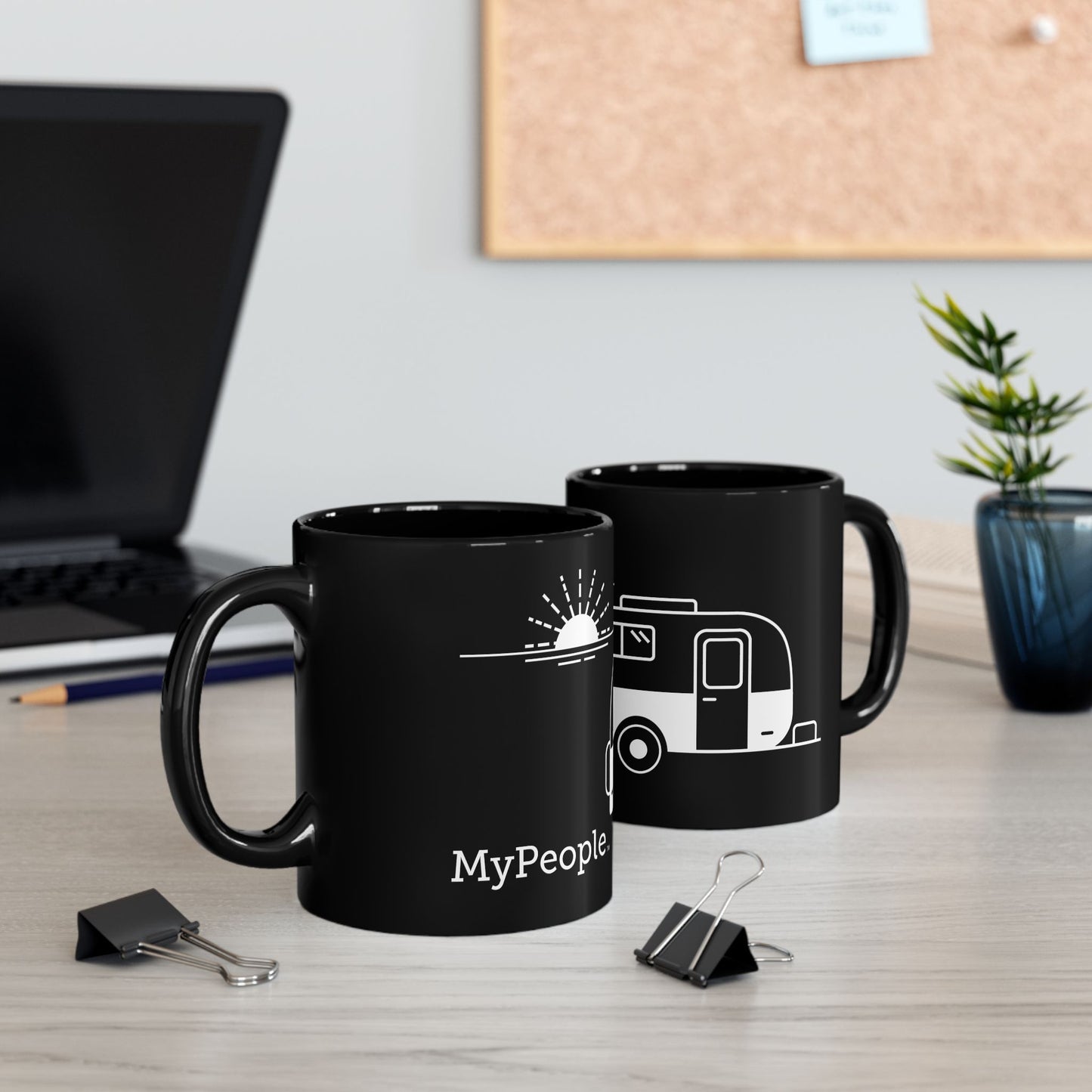 Two ceramic mugs featuring the MyPeople Vintage Trailer line illustration sitting on a desk.