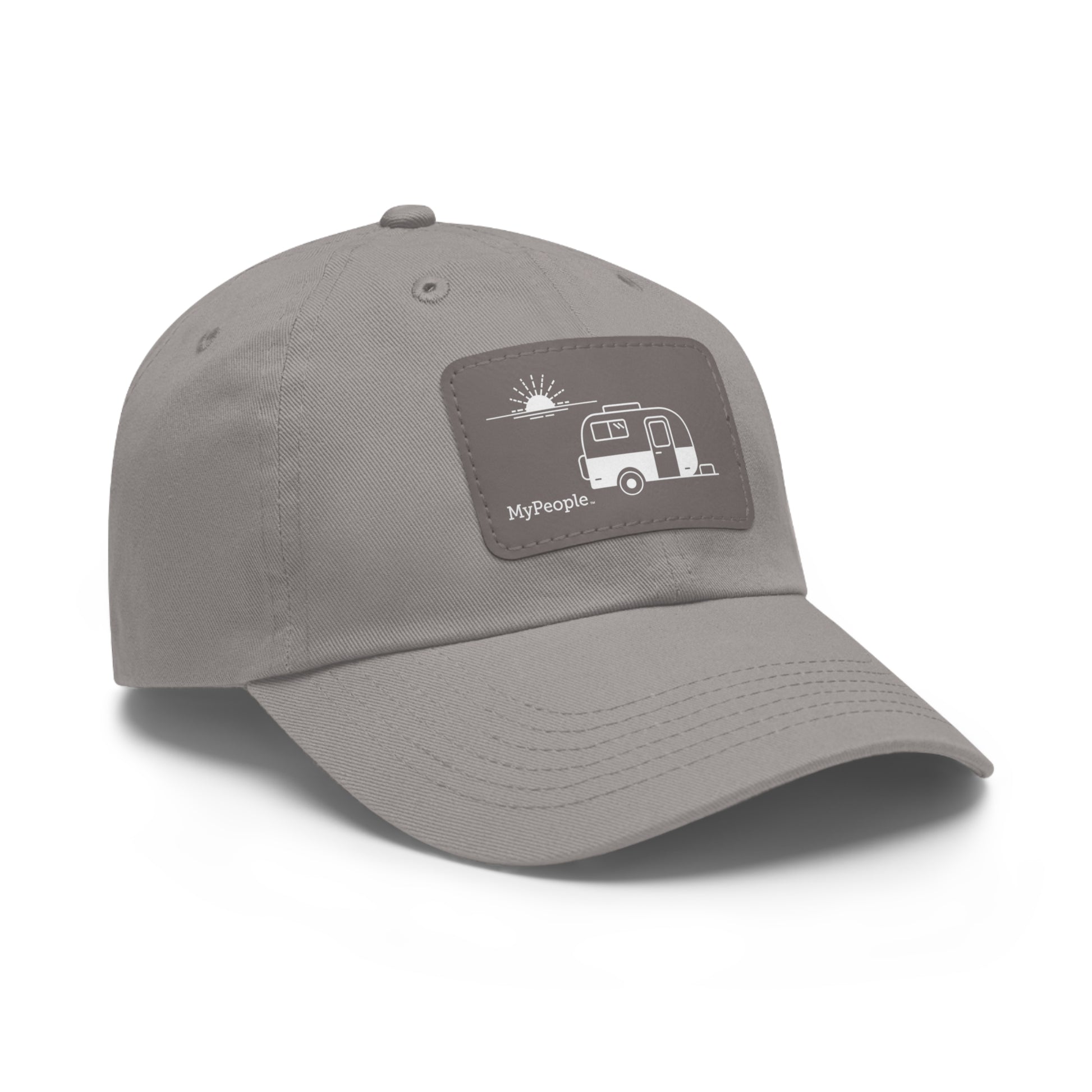 Angled view of a hat with a leather patch printed with the MyPeople Vintage Trailer line illustration.
