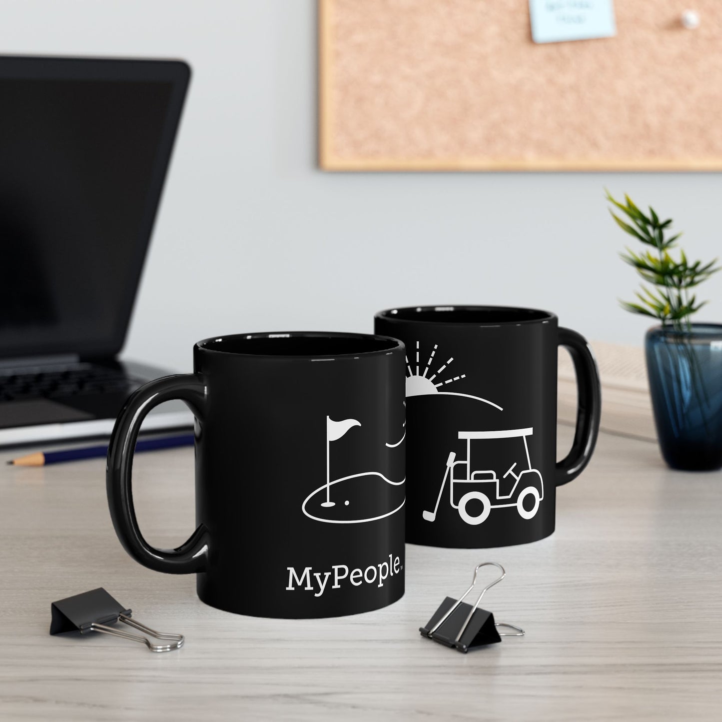 Two ceramic mugs featuring the MyPeople Golf line illustration sitting on a desk.
