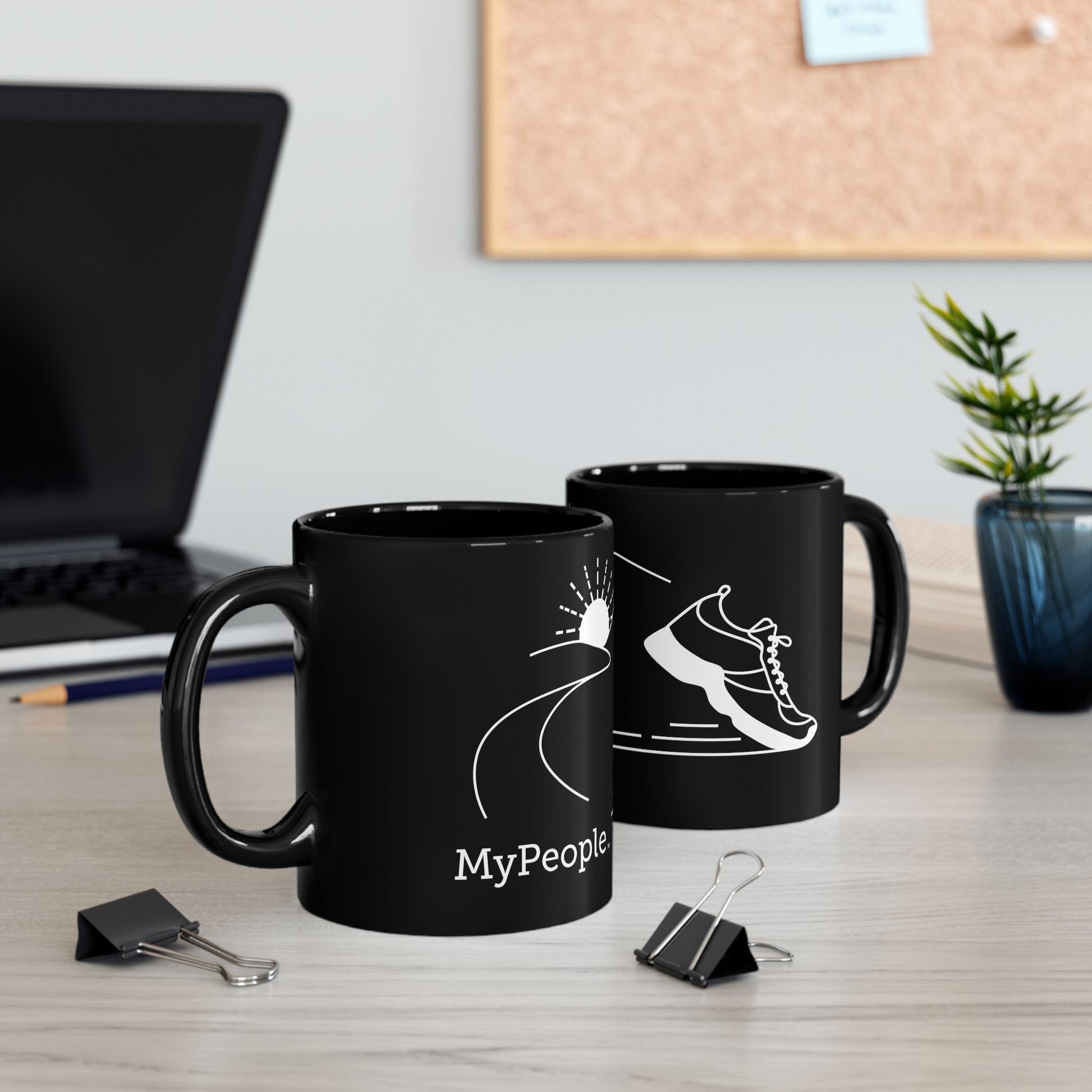 Two ceramic mugs featuring the MyPeople Running line illustration sitting on a desk.