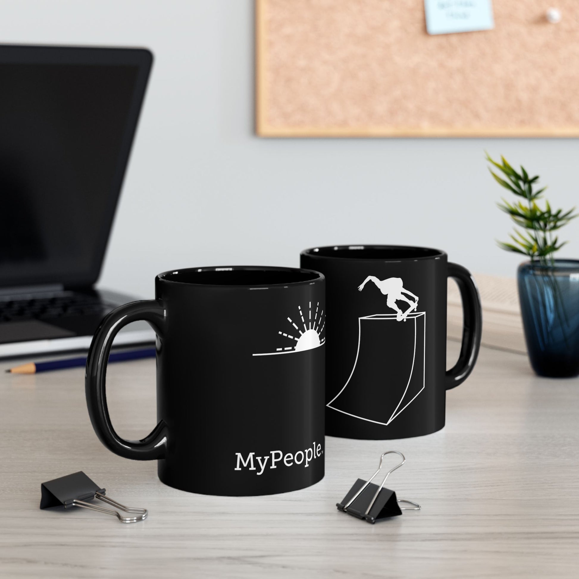 Two ceramic mugs featuring the MyPeople Skating line illustration sitting on a desk.